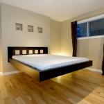 Bedroom,Fascinating Beige Wall Paint Floating Bed Design Ideas With Beautiful Black Bed Frame On Combined Soft White Mattress And Nice Brown Laminate Flooring Also Charming Black Curtains,Pleasured Floating Bed Ideas
