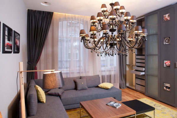 Apartments,Amazing White Wall Paint Studio Apartment Interior Design Inspiration With Charming Grey Sectional Sofa Plus Cool Brown Wood Coffe Table And Beautiful Great Glass Windows On Combined Soft White Curtains Also Elegant Chandelier ,Extraordinary Studio Apartment Interior Designs