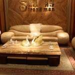 Furniture,Magnificent Sitting Room Design Ideas With Luxurious Cream Leather Sofas And Cool Coffe Table On Combined Beautiful Yellow Granite Table Also Elegant Pattern Area Rug ,Some Fancy Sitting Rooms