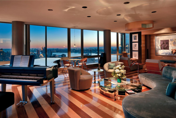 Living Room,Amazing Nyc Penthouse Design Ideas With Stylish Curved Gray Fabric Sofa And Cool Round Glass Table On Combined Beautiful Brown Cream Glossy Striped Floor Also Stunning Great Glass Windows ,Luxury Nyc Penthouses