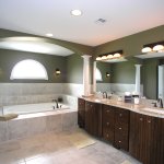 Bathroom,Exquisite Dark Green Wall Paint Wall Light Design Ideas With Amazing White Bathtub On Combined Soft Grey Marble Bath Panels And Stunning Double White Washbasin Also Trendy Brown Wood Vanity Cabinet,Classic Wall Lights Inside Bathroom