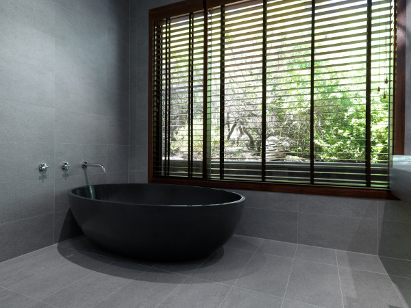 Bathroom,Nice Looking Large Space Black Free Standing Oval Shaped Stone Bathtub Design Ideas With Beautiful Stainless Wall Mount Bathroom Faucet And Cool Large Glass Window On Combined Nice Brown Blind Also Wonderful Gray Stone Tile,Beautiful Natural Stone Bathtub In Modern Bathroom