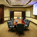 Furniture,Contemporary Large Space Top Office Design Inspiration With Stunning Brown Glossy Office Desk And Comfortable Black Leather Swivel Chairs Plus Nice Dark Brown Cabinet Also Gorgeous Dark Brown Wood Doors,Pleasant And Comfortable Top Office Designs