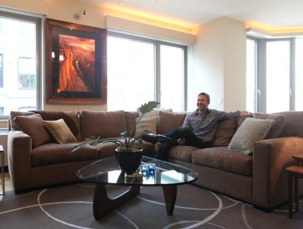 Apartments,Cool Amazing Cream Wall Paint Bachelor Apartment Design Inspiration With Beautiful Brown Fabric Sectional Sofa And Modern Glass Top Coffe Table On Combined Nice Potted Plant Also Wonderful Glass Windows,Exceptional Bachelor Apartment Designs
