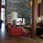 Interior,Trendy Large Double Sided Fireplace Stones Panels Wall Indoor Stone Fireplace Design Ideas With Comfortable Red Sofas And Unique Oversized Floor Lamps Also Amazing Large Coffe Table For Living Room,Amazing Indoor Stone Fireplace Designs To A Living Room