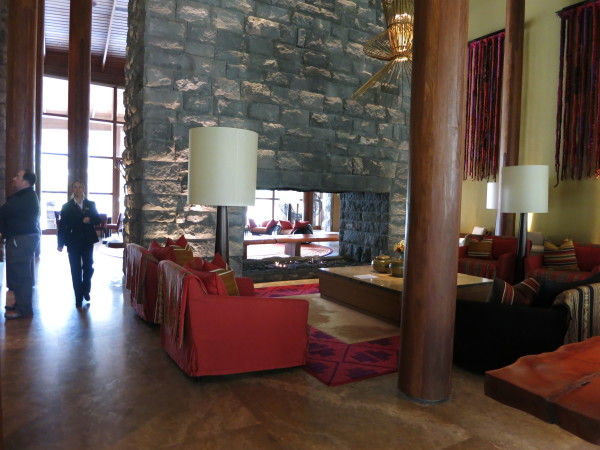 Interior,Trendy Large Double Sided Fireplace Stones Panels Wall Indoor Stone Fireplace Design Ideas With Comfortable Red Sofas And Unique Oversized Floor Lamps Also Amazing Large Coffe Table For Living Room,Amazing Indoor Stone Fireplace Designs To A Living Room