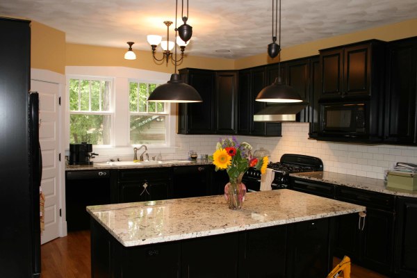 Furniture,Enthralling Yellow Black White Themed Kitchen Design Inspiration With Charming Black Wood Floating Kitchen Cabinet Plus Exquisite White Subway Tile Backspash And Cool Over Pendant Lamps In Beautiful Black Color Also Gorgeous Black Kitchen Island On Combined Wonderful White Granite Countertop,Luxury Kitchen Designers