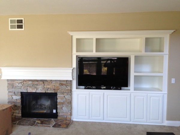 Furniture,Splendid Tv Wall Panel Design Ideas With Wonderful White Wooden Floating Entertaiment Center On Combined Storage And Modern Black Led Tv Also Cool Stack Stone Fireplace Mantle For Modern Concept,Modern Tv Wall Panel Designs