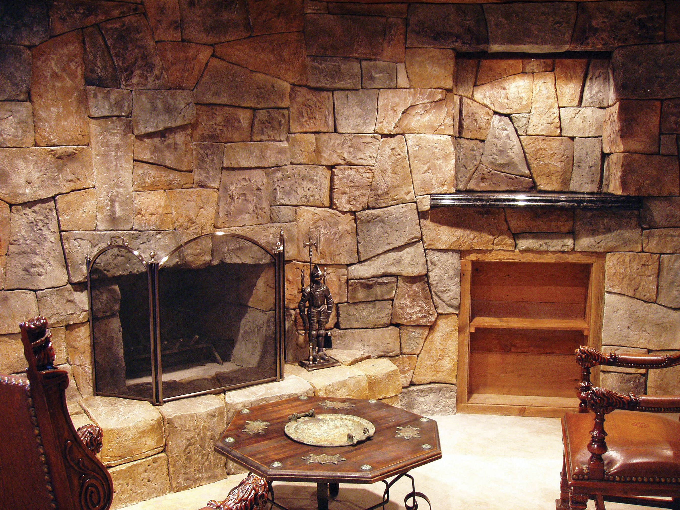 Interior,Stunning Indoor Stone Fireplace Design With Amazing Stone Wall And Beautiful Bright Brown Wooden Rack Plus Vintage Brown Hexagons Table Also Comfortable Brown Leather Chairs,Amazing Indoor Stone Fireplace Designs To A Living Room