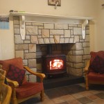 Interior,Winsome Cream Wall Paint Stone Fire Places Design Ideas With Cool Bit Stone Edge Fireplace And Beautiful White Wood Wall Mount Shelf Also Comfortable Brown Wood Armchairs On Combined Soft Red Thick Padded Seat,The Beauty Of Stone Fire Places Your Home Inspiration