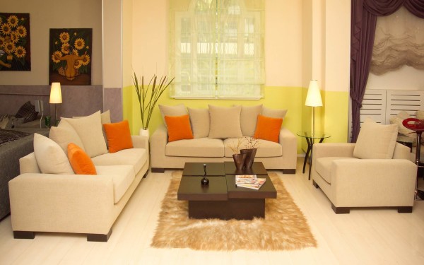 Interior,Beautiful Open Plan Interior Designer Living Room Design Ideas With Cozy Light Brown Fabric Sofas On Combined Soft Orange Cushions And Unique Dark Brown Coffe Table Plus Soft Bright Brown Fur Rug Also Cool Glass Round Accent Table Using Beautiful Cream Cup Table Lamps,The Best High Quality And Cheap Interior Designer Living Rooms