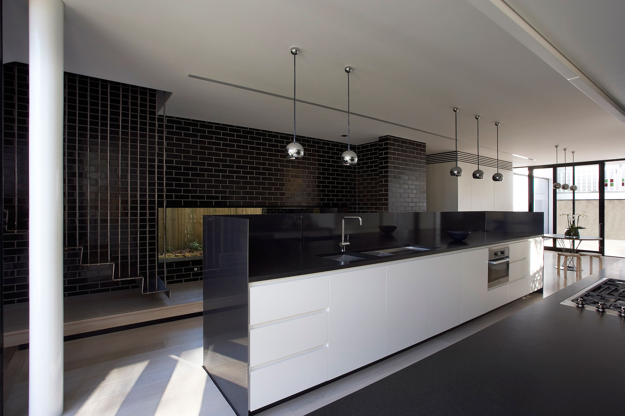 Furniture,Modern Interior Design Architect With Beautiful White Kitchen Cabinet On Combined Nice Black Countertop And Cool Oven Stove Built In Craft Also Gorgeous Chrome Hanging Lamps Using Rustic Black Brick Tile Wall,Modern Interior Design Architects For Your Homes