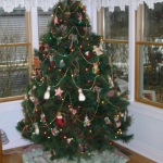 Furniture,Gorgeous White Wall Paint Design Christmas Tree Ornament With Extraordinary Green Corner Christmas Tree Plus Beautiful Xmas Tree Lights And Nice Brown Wood Floor Also Cool Glass Windows,Spectacular Designer Christmas Tree Ornaments