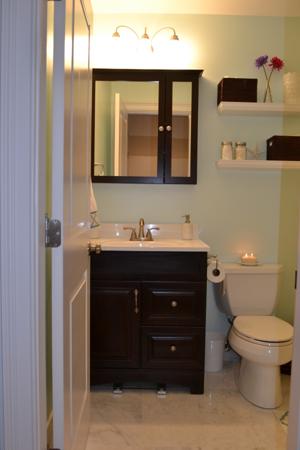 Bathroom,Marvelous Light Blue Wall Paint Design Small Bathroom With Charming Black Wood Vanity Cabinet Plus Beautiful White Ceramic Countertop And Wonderful Glass Mirror Also Gorgeous White Ceramic Closet Seat On Combined Amazing White Granite Floor ,Amazing Designing Small Bathrooms