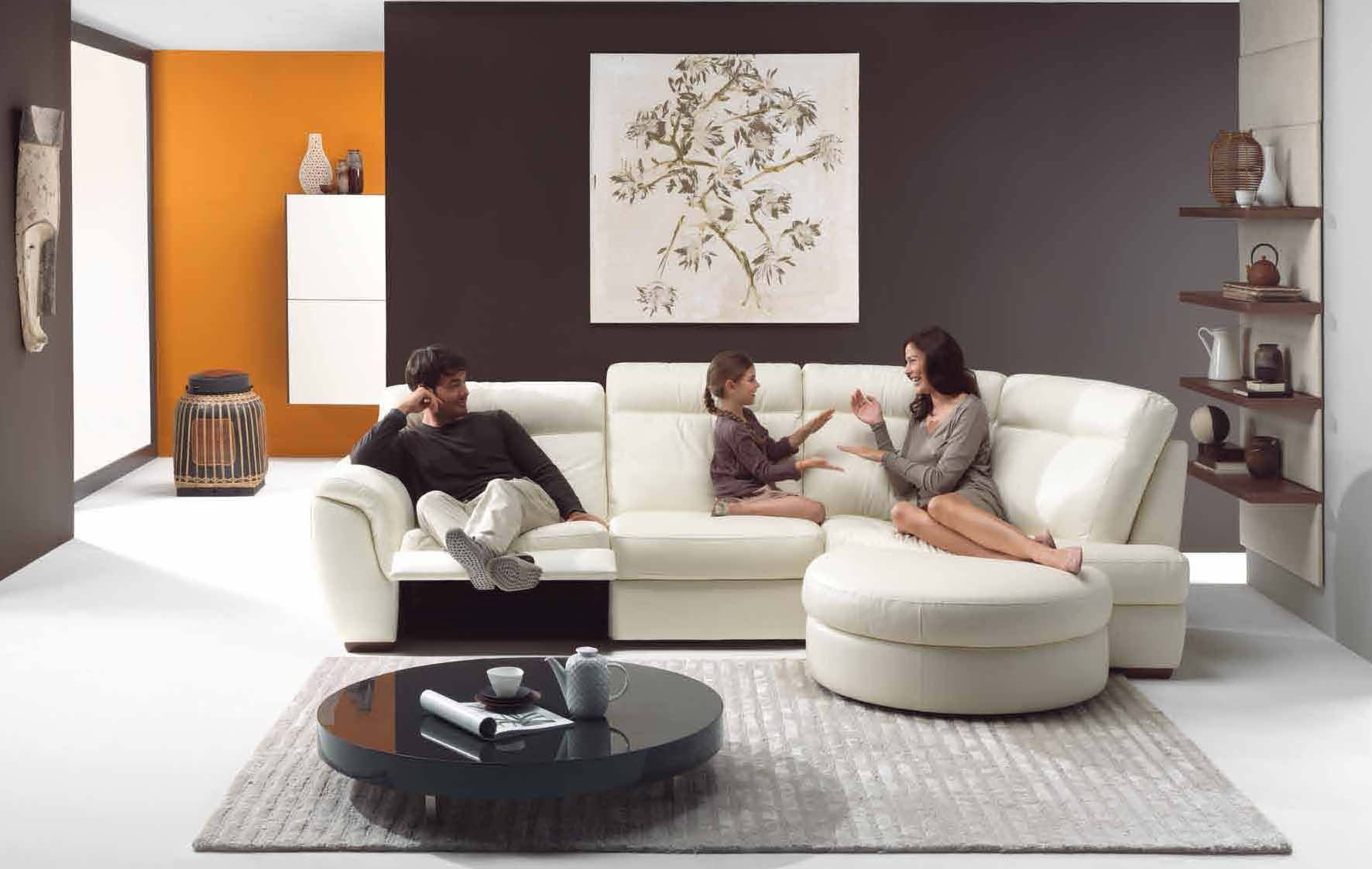 Interior,Cool Stylish Interior Designer Living Room Decoration With Comfortable White Sofa And Cool Round Black Wooden Table On The Gray Rug Plus Soft White Ottoman Also Wonderful Black Orange Wall Paint,The Best High Quality And Cheap Interior Designer Living Rooms