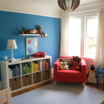 Bedroom,Trendy Blue White Wall Paint Children Bedroom Design With Charming White Wood Bed Frame And Nice White Wood Open Storage Plus Soft White Blue Striped Rug On Combined Nice Brown Wood Floor Also Comfortable Red Single Seater Sofa,Cool Stylish With Themed Children Bedroom Designs