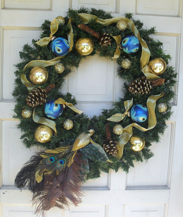 Interior,Fascinating White Wood Door Christmas Wreath Decorating Ideas With Charming Green Pine Cones Christmas Wreath And Beautiful Gold Mesh Ribbon Plus Gorgeous Gold Blue Christmas Balls Also Cool Peacock Feather Ornaments In Beautiful Dark Brown Color,Make Your Guests Be Impressed To See The Christmas Wreath Decorating Ideas