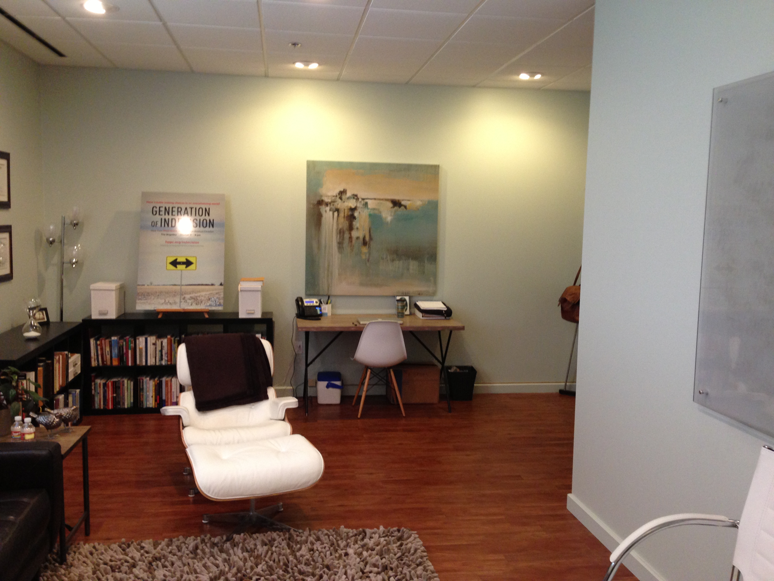 Furniture,Impressive White Ceiling Psychotherapy Office Decor With Stylish Study Space And Cool Open Book Shelves Also Modern White Single Seater Sofa Plus Gorgeous White Ottoman On Combined Trendy Brown Laminate Flooring,Cool Psychotherapy Office Decor In Home 