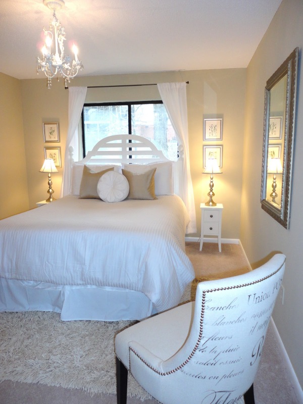 Bedroom,Marvelous Decoration Ideas Bedroom With Comfortable Large White Bedding And Beautiful Two White Wood Nightstand Table Combined Nice Table Lamps Also Cozy White Leather Single Seater Sofa Plus Elegant White Chandelier For Luxurious Concept,Inexpensive Decorating Ideas For Bedrooms
