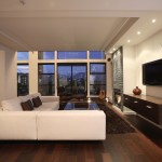 Furniture,Fancy Large Space Interior Design With Modern White Leater Sectional Sofa And Cool Glass Table Plus Soft Black Fur Rug On Combined Nice Hardwood Floor Also Splendid Tv Wall Units On The White Wall,Cool Home Interior Designs Of 2015