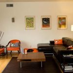 Apartments,Exquisite White Mixed Cream Wall Paint Apartment Ideas With Comfortable Black Sectional Sofa And Nice Brown Square Table On Combined Trendy Black Rug Also Cozy Orange Chairs Plus Trendy Bright Brown Wood Floor,Comfort Studio For Contemporary Apartment Ideas