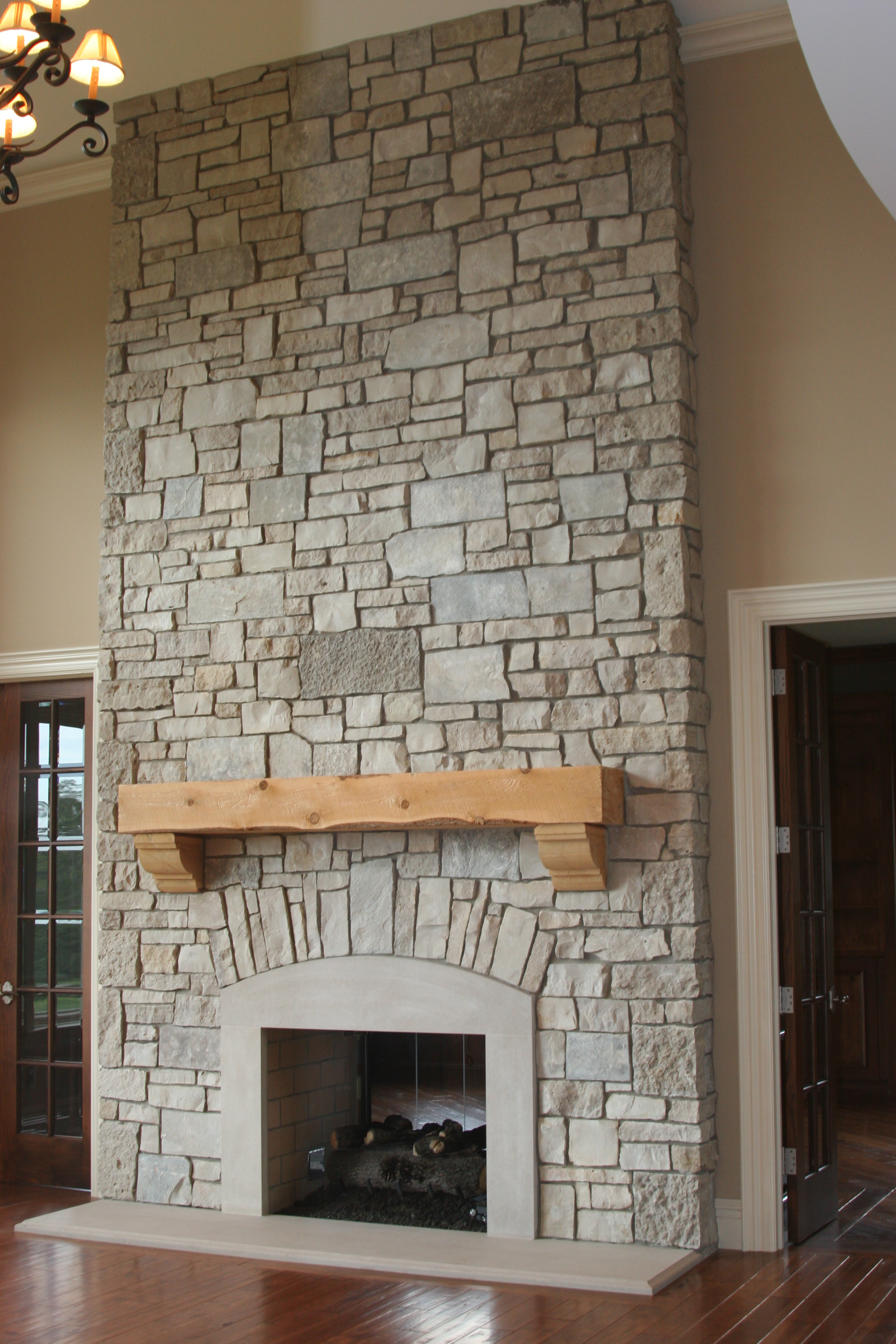 Interior,Enticing Light Brown Wall Paint Stone Fire Places Design Ideas With Wonderful Wall Tiles Cast Stone Fireplace And Cool Bright Brown Wood Wall Mount Shelf Also Trendy Dark Brown Wood Linen Floor,The Beauty Of Stone Fire Places Your Home Inspiration