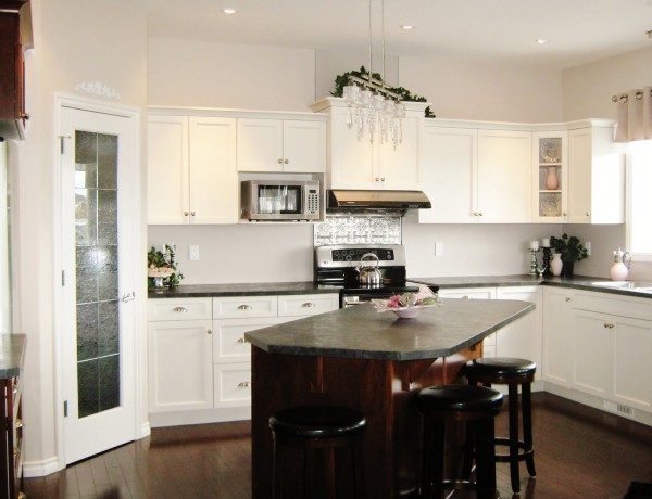 Interior,Extraordinary White Wall Paint Small Luxury Kitchen Design Ideas With Trendy White Wood Kitchen Cabinet On Combined Nice Black Marble Countertop And Elegant White Wood Floating Kitchen Cabinet Also Gorgeous Black Brown Bar Table Plus Comfortable Three Black Leather Bar Stool,Best Small Luxury Kitchens Inspiration
