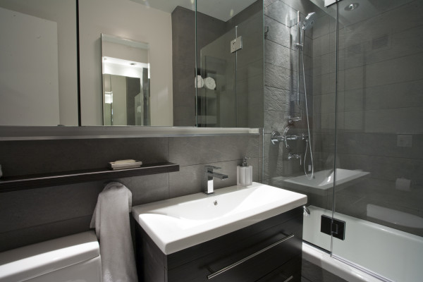 Bathroom,Marvelous Gray Stone Tile Wall Best Modern Bathroom Design Ideas With Beautiful Black Wood Bathroom Vanity On Combined Cool White Ceramic Countertop And Wonderful Stainless Single Hole Bathroom Faucet Also Nice Bathtub Shower Door Plus Gorgeous Stainless Shower Head,The Best Modern Bathrooms Design Great