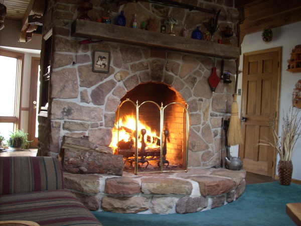 Interior,Rustic Stone Fire Places Design Ideas With Stylish Light Brown Stone Dorm Firaplace And Nice Brown Wood Wall Mount Shelf Also Comfortable Colorful Striped Sofa Plus Soft Large Blue Carpet,The Beauty Of Stone Fire Places Your Home Inspiration