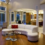 Interior,The Best Beautiful Interior Designer Living Room Design Inspiration With Comfortable White Leather Sofa Plus Soft Red Cushions And Cool Round Glass Table On Combined Trendy Brown Wood Floor Also Comfortable Breakfast Nook,The Best High Quality And Cheap Interior Designer Living Rooms
