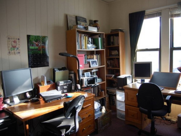 Furniture,Fascinating White Wood Wall Painted Home Office Design For Two People With Stylish Brown Double Office Desk And Comfortable Black Two Fabric Arm Chair Also Wofnderul Bookcase In Brown Color ,Comfortable Home Office Design For Two People 