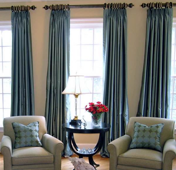 Furniture,Extraordinary Cream Wall Paint Loft Window Curtain Design With Stunning Blue Large Curtains And Comfortable Single Seater Sofa On Combined Soft Blue Cushions Also Wonderful Black Wood Accent Round Table Plus Nice White Desk Lamp,Good Looking Living Room Loft Window Curtains