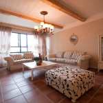 Furniture,Beautiful Large Space Sitting Room Design Ideas With Charming White Black Sofas Plus Nice White Coffe Table On Combined Wonderful Brown Ceramic Tile Floor And Soft Black White Ottoman Also Stunning Clear Glass Door Standing Cabinet ,Some Fancy Sitting Rooms