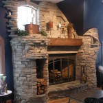 Interior,Breathtaking Blue Wall Paint Stone Fire Places Decoration With Awesome Corner Brick Stone Firaplace And Beautiful Brown Wood Wall Mount Shelf Also Cool Dark Brown Wood Coffe Table On Combined Splendid Bright Brown Wood Floor,The Beauty Of Stone Fire Places Your Home Inspiration