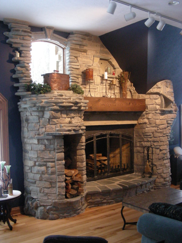 Interior,Breathtaking Blue Wall Paint Stone Fire Places Decoration With Awesome Corner Brick Stone Firaplace And Beautiful Brown Wood Wall Mount Shelf Also Cool Dark Brown Wood Coffe Table On Combined Splendid Bright Brown Wood Floor,The Beauty Of Stone Fire Places Your Home Inspiration
