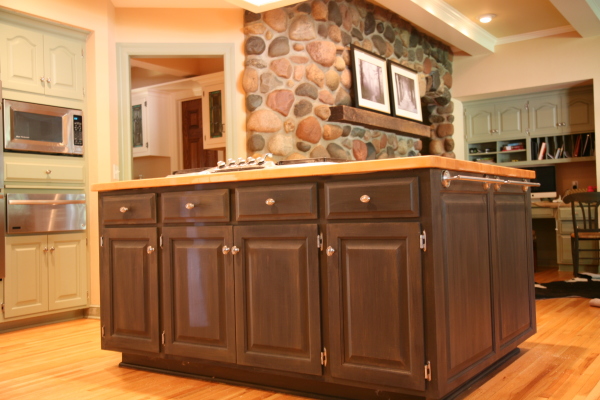 Furniture,Dazzling Stone Wall Panel Cabinet Door Design Ideas With Gorgeous Brown Wood Kitchen Island Plus Nice Yellow Countertopn And Adorable Oven Stove Built In Craft Also Splendid Bright Brown Wood Floor,Unique Cabinet Doors For Kitchen