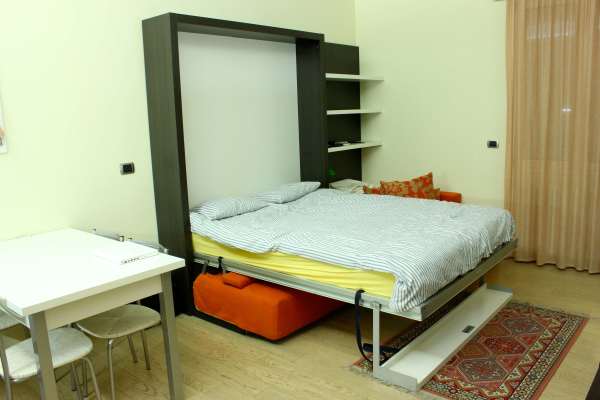 Bedroom,Unusual Green Lime Wall Paint Murphy Bed Design Inspiration With Nice Black Wood Bed Frame On Combined Soft Yellow Bed Sheet And Wonderful White Striped Blanket Also Splendid White Square Table Plus Cozy White Chairs,Uniquely Murphy Bed Inspiration For Your Bedroom
