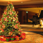 Furniture,Enticing Large Space Best Christmas Decorating Ideas With Exquisite Green Christmas Tree On Combined Beautiful Red Golden Ball Ornament And Gorgeous Having Red Series Ribbon Flowers Also Soft Cream Pattern Round Rug,The Best Christmas Decorating Ideas And Christmas Tree For Your Home