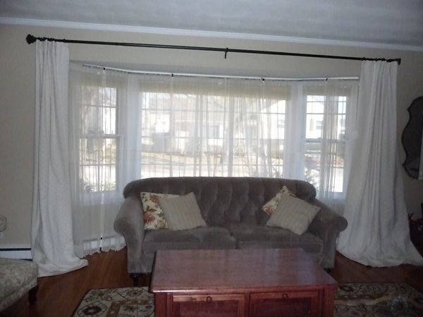 Interior,Exquisite Curtain Ideas For Large Window With Stylish Curved Large White Curtains And Soft Brown Fabric Two Seater Sofa And Cozy Pillow Also Nice Brown Square Wood Table For Living Room,Curtain Ideas For Large Windows