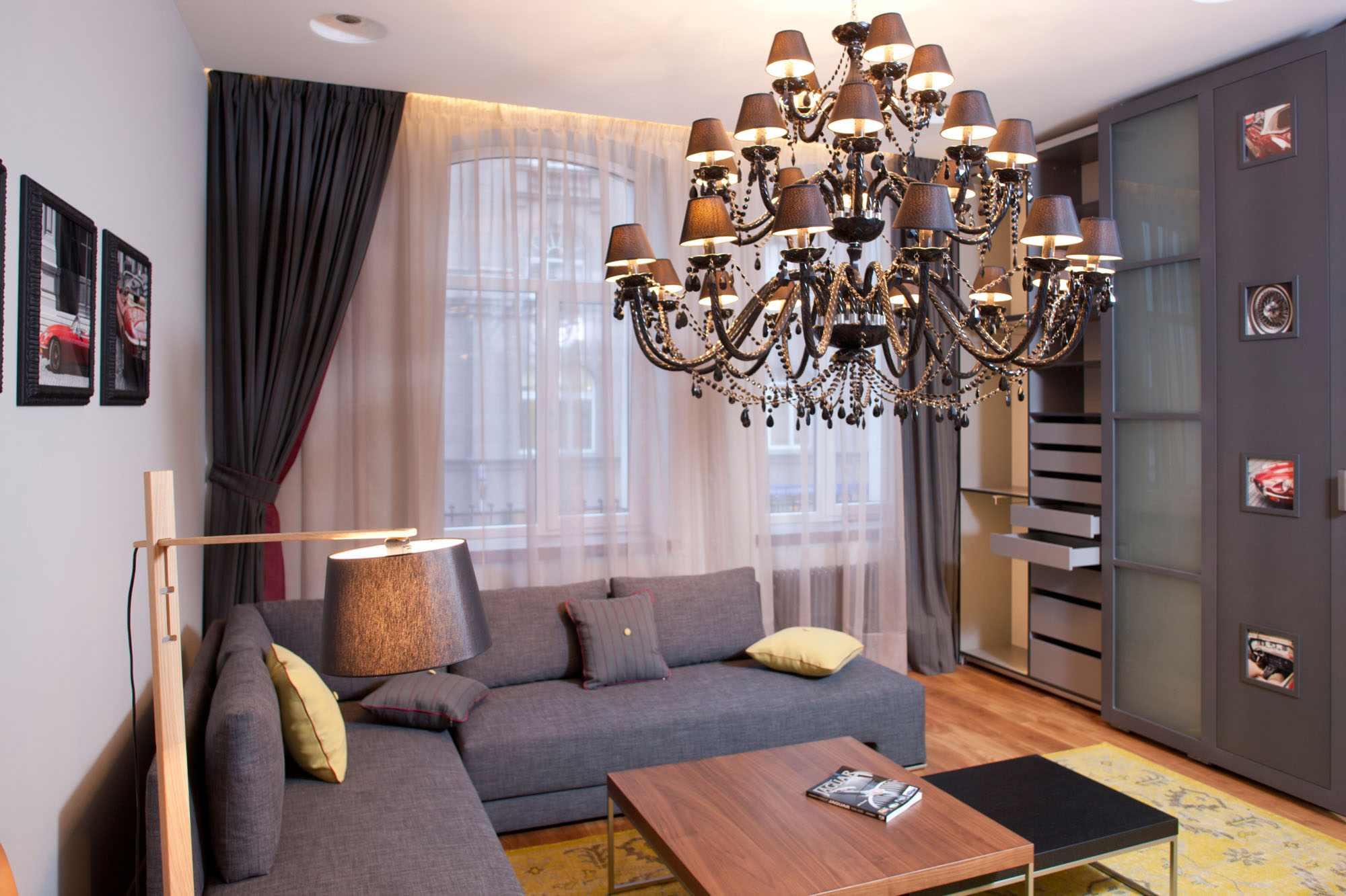 Apartments,Amazing White Wall Paint Studio Apartment Interior Design Inspiration With Charming Grey Sectional Sofa Plus Cool Brown Wood Coffe Table And Beautiful Great Glass Windows On Combined Soft White Curtains Also Elegant Chandelier ,Extraordinary Studio Apartment Interior Designs
