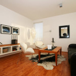 Furniture,Impressive Interior Design Architect With Comfortable Black Leather Sofa And Nice Brown Black Rectangular Table On Combined Black White Cowhide Rug Plus Cool White Chairs Also Picturesque Black Picture Frames On The White Wall,Modern Interior Design Architects For Your Homes
