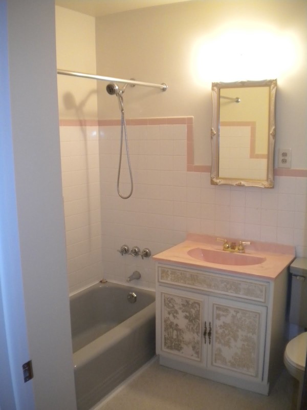 Bathroom,Enchanting White Wall Paint Small Bathroom Design Idea With Luxurious White Pattern Bathroom Vanity On Combined Beautiful Gold Moen Bathroom Faucet Plus Nice Vertical Wall Mirror And Comfortable Gray Ceramic Bathtub Also Gorgeous Shower Head,The Best Beautiful And Small Bathroom Design Ideas