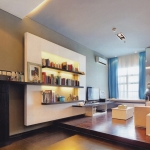 Apartments,Awesome Large Space Studio Apartment Interior Design Ideas With Stunning Cream Single Seater Sofa On Combined Nice Brown Laminate Flooring And Beautiful Entertainment Tv Plus Wonderful Great Open Book Shelves Also Adorable Blue White Curtains ,Extraordinary Studio Apartment Interior Designs