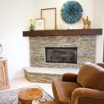 Interior,Modern White Wall Paint Indoor Stone Fireplace Design Ideas With Wonderful Stone Fireplace And Rustic Bright Brown Wood Cabinet Also Comfortable Brown Leather Single Seater Sofa,Amazing Indoor Stone Fireplace Designs To A Living Room