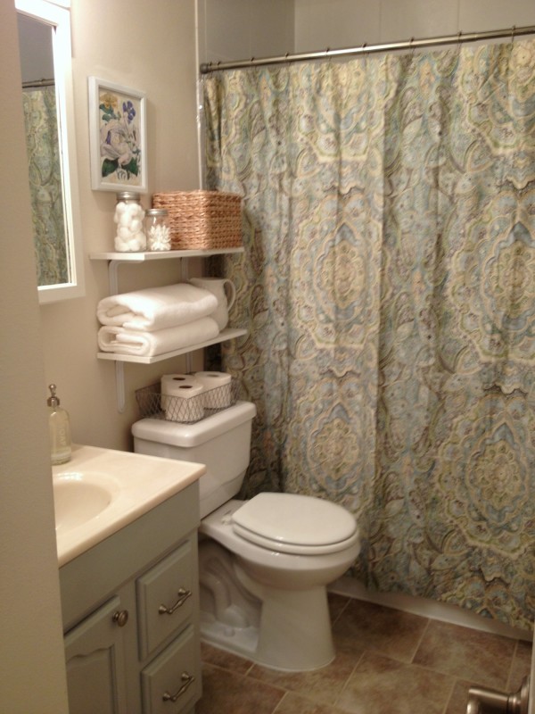 Bathroom,Adorable Cream Wall Paint Bathroom Storage Ideas For Small Bathroom With Amazing Floating Light Blue Wood Bathroom Vanity On Combined Beautiful White Countertop And Nice Vertical Wall Mirror Also Comfortable White Ceramic Toilet Plus Wonderful Brown Ceramic Tile Floor,Cool Neat Bathroom Storage Ideas For Small Bathrooms