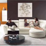 Interior,Cool Stylish Interior Designer Living Room Decoration With Comfortable White Sofa And Cool Round Black Wooden Table On The Gray Rug Plus Soft White Ottoman Also Wonderful Black Orange Wall Paint,The Best High Quality And Cheap Interior Designer Living Rooms