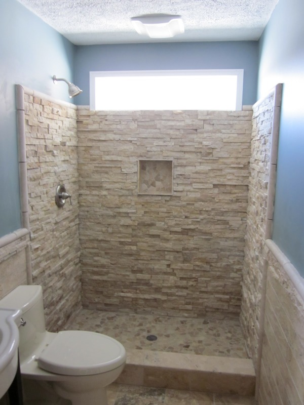 Bathroom,Amazing Cream Stone Brick Wall Shower Design Small Bathroom With Charming Shower Faucet And Cozy White Ceramic Closet Seat Also Beautiful Blue Wall Paint ,Amazing Designing Small Bathrooms